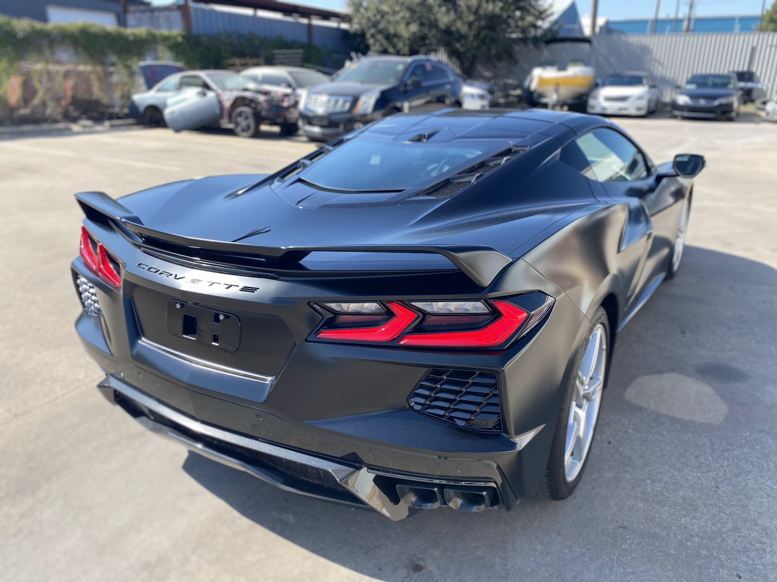 Rear view of a satin black Corvette C8 repainted at 8SRT Collision and Paint